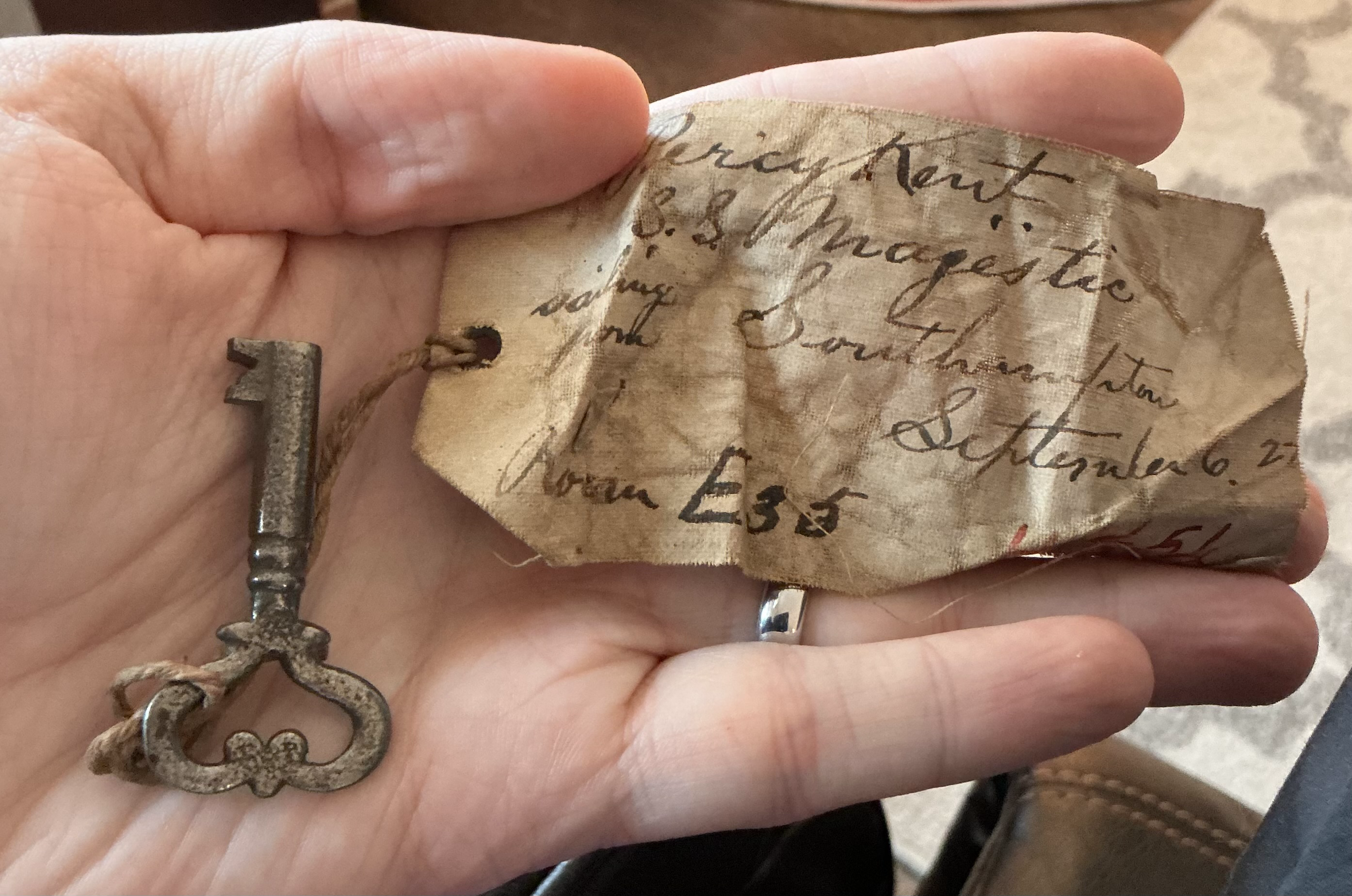 Antique skeleton key with attached cloth tag reading 'S.S. Majestic' (claimed)